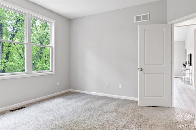 unfurnished room featuring baseboards and carpet flooring