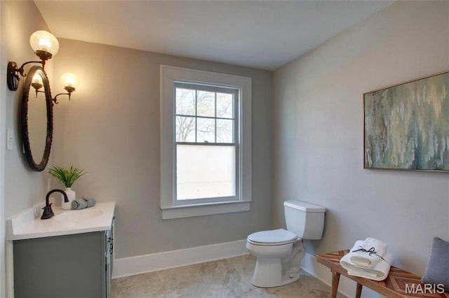 410 White St, Canton, MO 63435 - bathroom with plenty of natural light, toilet, vanity, and baseboards