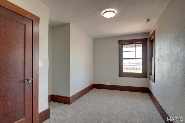 410 White St, Canton, MO 63435 - unfurnished room with carpet flooring, baseboards, and a textured ceiling