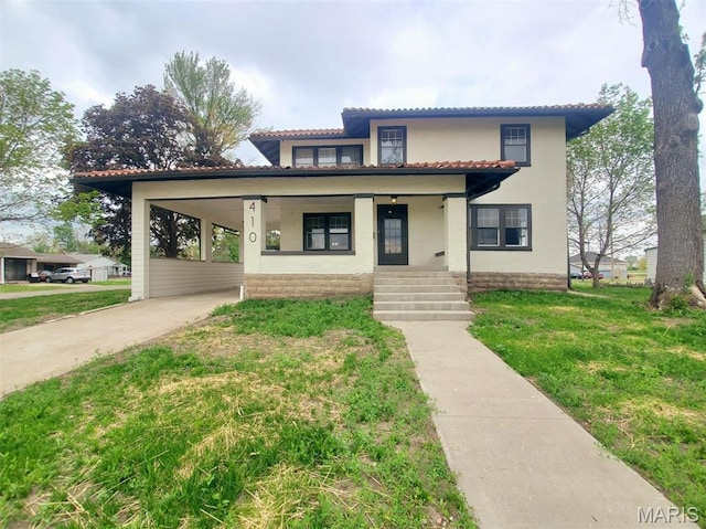 410 White St, Canton, MO 63435 - view of front facade featuring concrete driveway, a tiled roof, a front lawn, a porch, and an attached carport