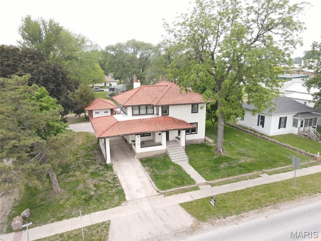 410 White St, Canton, MO 63435 - mediterranean / spanish-style house with concrete driveway, a tile roof, stucco siding, a chimney, and a porch