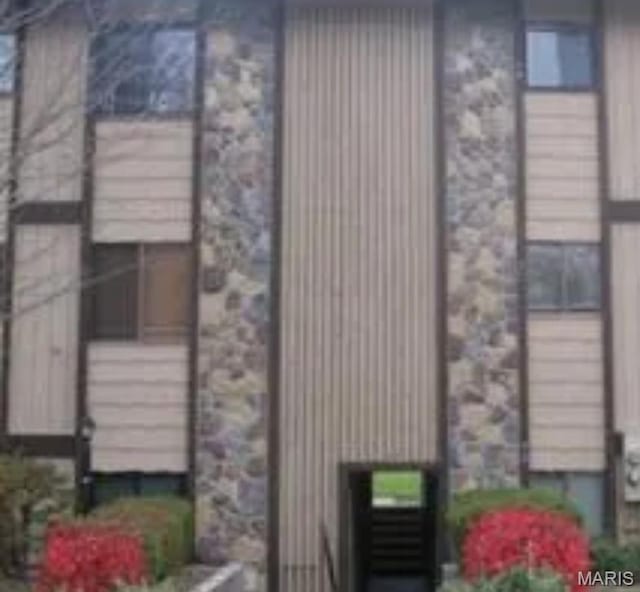 80 Lemans Ct Unit 80, Lake St Louis, MO 63367 - view of home's exterior featuring stone siding