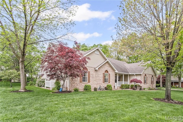 1302 Walnut St, Jerseyville, IL 62052 - view of front facade featuring brick siding, a front lawn, and a porch