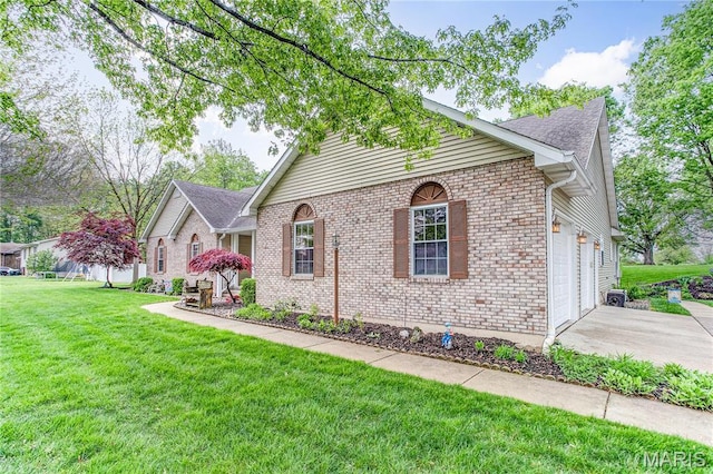 1302 Walnut St, Jerseyville, IL 62052 - view of front of house featuring concrete driveway, a front lawn, a garage, and brick siding