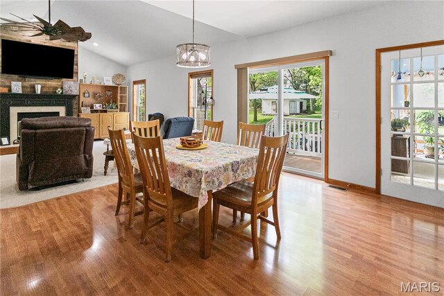 1302 Walnut St, Jerseyville, IL 62052 - dining space with light wood-style floors, ceiling fan, lofted ceiling, a fireplace, and baseboards