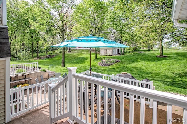 1302 Walnut St, Jerseyville, IL 62052 - view of grassy yard with an outdoor fire pit, a wooden deck, and view of wooded area