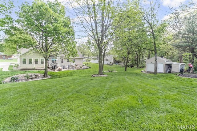 1302 Walnut St, Jerseyville, IL 62052 - view of green lawn featuring a garage and an outbuilding