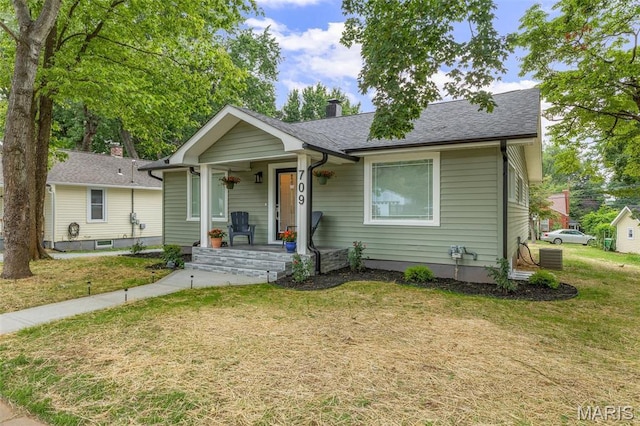 709 Warren St, Farmington, MO 63640 - bungalow featuring a porch, a front lawn, and a chimney