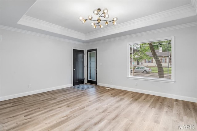 709 Warren St, Farmington, MO 63640 - unfurnished room featuring a chandelier, ornamental molding, light wood-style flooring, a tray ceiling, and baseboards