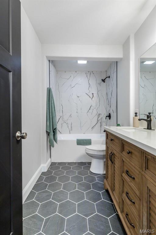709 Warren St, Farmington, MO 63640 - full bathroom with toilet, vanity, shower / bathtub combination, and tile patterned flooring