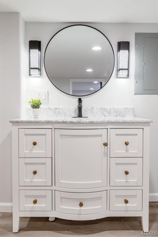 709 Warren St, Farmington, MO 63640 - bathroom with baseboards, vanity, and wood finished floors