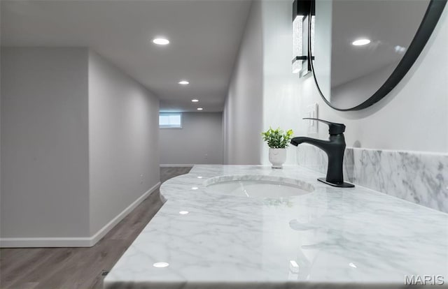 709 Warren St, Farmington, MO 63640 - bathroom view of baseboards, wood finished floors, recessed lighting, and vanity