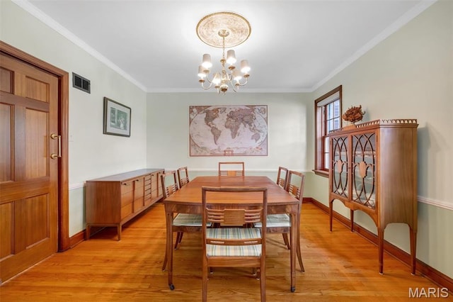 7423 Tulane Ave, Saint Louis, MO 63130 - dining space with light wood finished floors, a chandelier, and ornamental molding