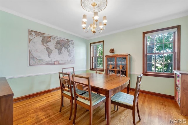 7423 Tulane Ave, Saint Louis, MO 63130 - dining space featuring a chandelier, light wood-style flooring, and ornamental molding