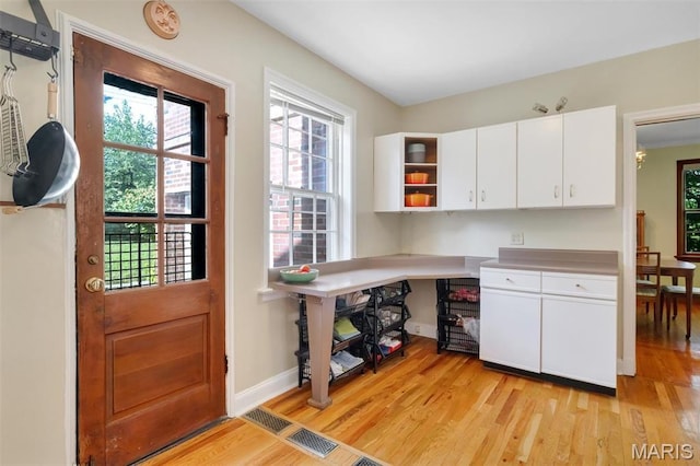 7423 Tulane Ave, Saint Louis, MO 63130 - kitchen featuring light wood-style floors, plenty of natural light, and white cabinetry
