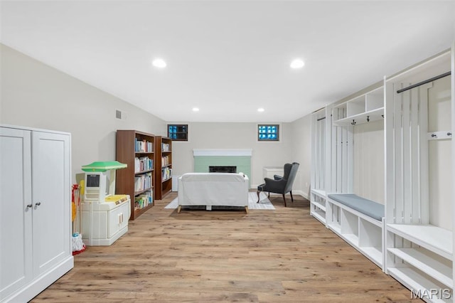 7423 Tulane Ave, Saint Louis, MO 63130 - bedroom with a fireplace, light wood-style flooring, and recessed lighting