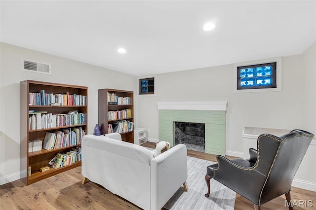 7423 Tulane Ave, Saint Louis, MO 63130 - living area with light wood-style floors, recessed lighting, and a fireplace