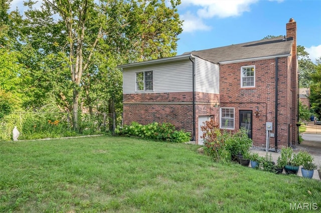 7423 Tulane Ave, Saint Louis, MO 63130 - back of house with brick siding and a chimney