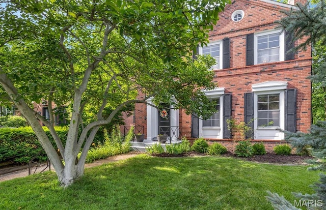 7423 Tulane Ave, Saint Louis, MO 63130 - view of front of home featuring brick siding and a front yard