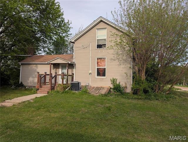 8777 State Route 162, Troy, IL 62294 - rear view of house with a lawn, central air condition unit, and a wooden deck