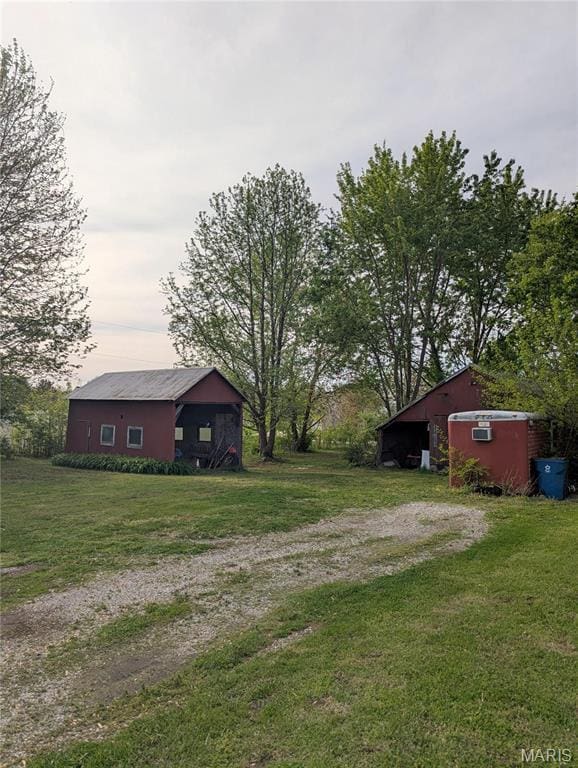 8777 State Route 162, Troy, IL 62294 - view of green lawn featuring an outdoor structure, a pole building, and driveway