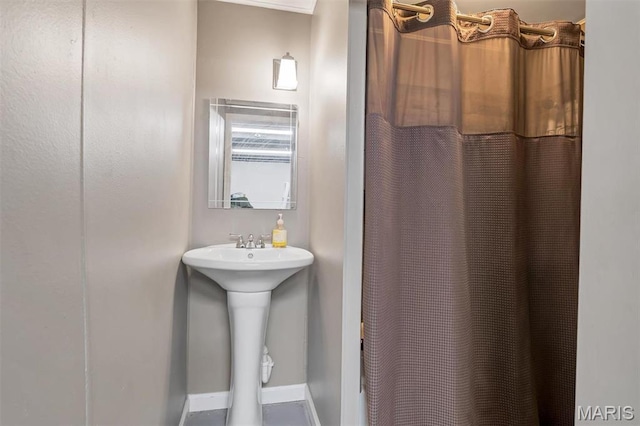 full bathroom with baseboards, curtained shower, and a sink