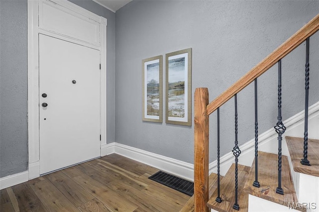 2148 Oregon Ave, Saint Louis, MO 63104 - entryway featuring dark wood finished floors, baseboards, and stairway