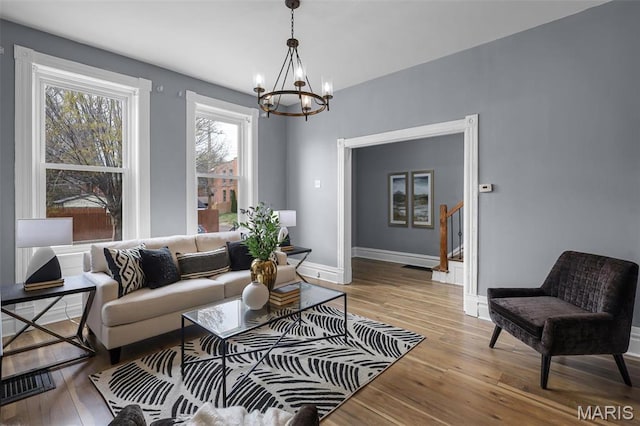 2148 Oregon Ave, Saint Louis, MO 63104 - living area featuring a chandelier, light wood-style flooring, and baseboards