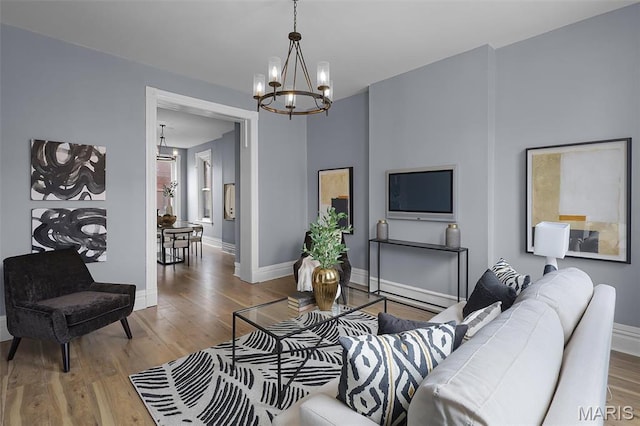 2148 Oregon Ave, Saint Louis, MO 63104 - living area with a chandelier, wood finished floors, and baseboards
