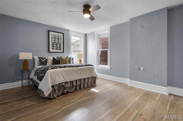 2148 Oregon Ave, Saint Louis, MO 63104 - bedroom featuring a textured ceiling, wood finished floors, baseboards, and ceiling fan