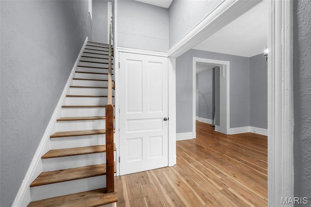 2148 Oregon Ave, Saint Louis, MO 63104 - staircase featuring wood finished floors, baseboards, and a textured wall