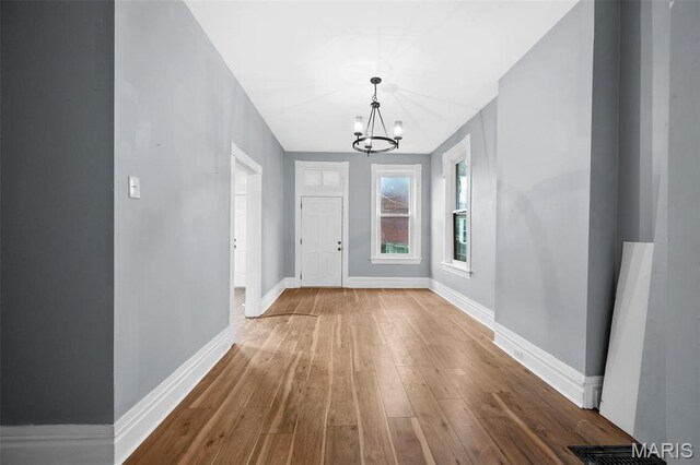 2148 Oregon Ave, Saint Louis, MO 63104 - foyer entrance featuring a chandelier, wood finished floors, and baseboards
