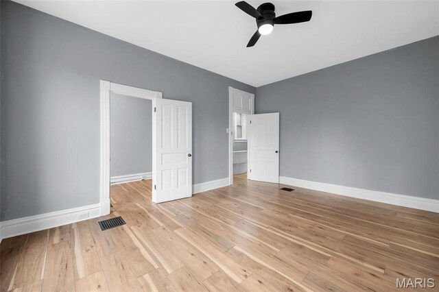2148 Oregon Ave, Saint Louis, MO 63104 - unfurnished bedroom with baseboards, light wood-type flooring, and ceiling fan