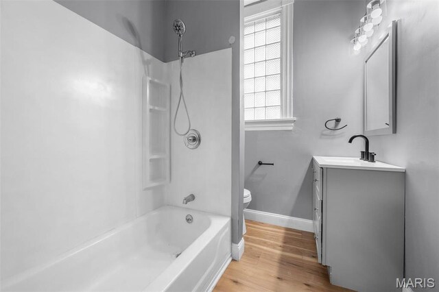2148 Oregon Ave, Saint Louis, MO 63104 - full bathroom with vanity, toilet, wood finished floors, shower / washtub combination, and baseboards