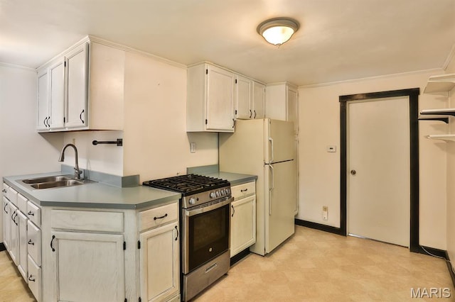1046 Marshall Ave, Saint Louis, MO 63119 - kitchen with gas stove, a sink, freestanding refrigerator, light flooring, and white cabinetry