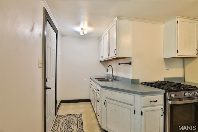 1046 Marshall Ave, Saint Louis, MO 63119 - kitchen featuring stainless steel range with gas stovetop, a sink, white cabinetry, and baseboards