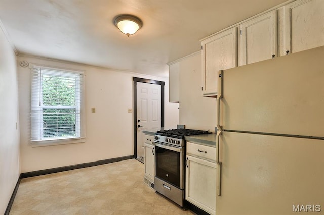 1046 Marshall Ave, Saint Louis, MO 63119 - kitchen featuring freestanding refrigerator, stainless steel gas range, baseboards, light flooring, and ornamental molding