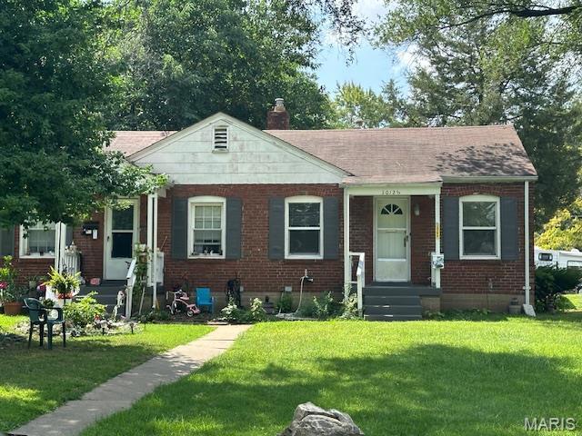 3409 Saint Gregory Ln, Saint Ann, MO 63074 - bungalow featuring brick siding, a front lawn, a chimney, and crawl space