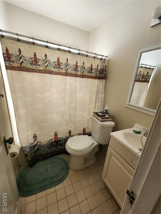3409 Saint Gregory Ln, Saint Ann, MO 63074 - bathroom featuring toilet, vanity, tile patterned floors, and a shower with shower curtain