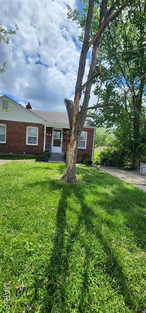 3409 Saint Gregory Ln, Saint Ann, MO 63074 - view of front of home with brick siding and a front lawn