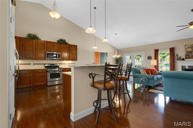 341 Brunhaven Ct, Chesterfield, MO 63017 - kitchen with appliances with stainless steel finishes, open floor plan, dark wood-type flooring, high vaulted ceiling, and brown cabinetry