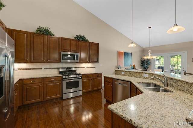 341 Brunhaven Ct, Chesterfield, MO 63017 - kitchen with appliances with stainless steel finishes, high vaulted ceiling, dark wood-type flooring, tasteful backsplash, and hanging light fixtures
