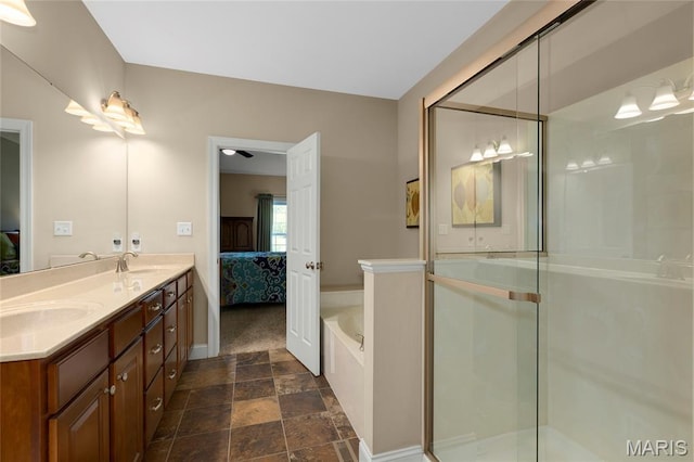 341 Brunhaven Ct, Chesterfield, MO 63017 - full bath with ensuite bathroom, double vanity, a garden tub, stone finish flooring, and a shower with shower door
