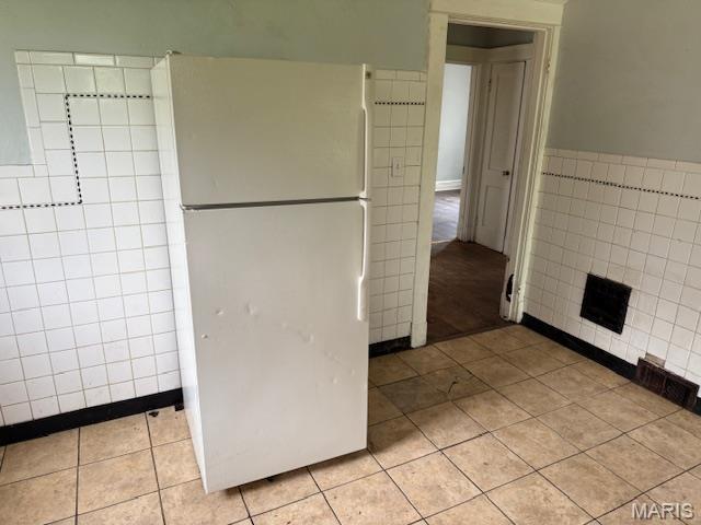 bathroom with tile walls and tile patterned floors