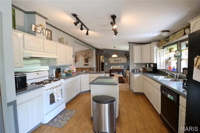 kitchen with white gas range, dishwasher, a sink, under cabinet range hood, and a peninsula