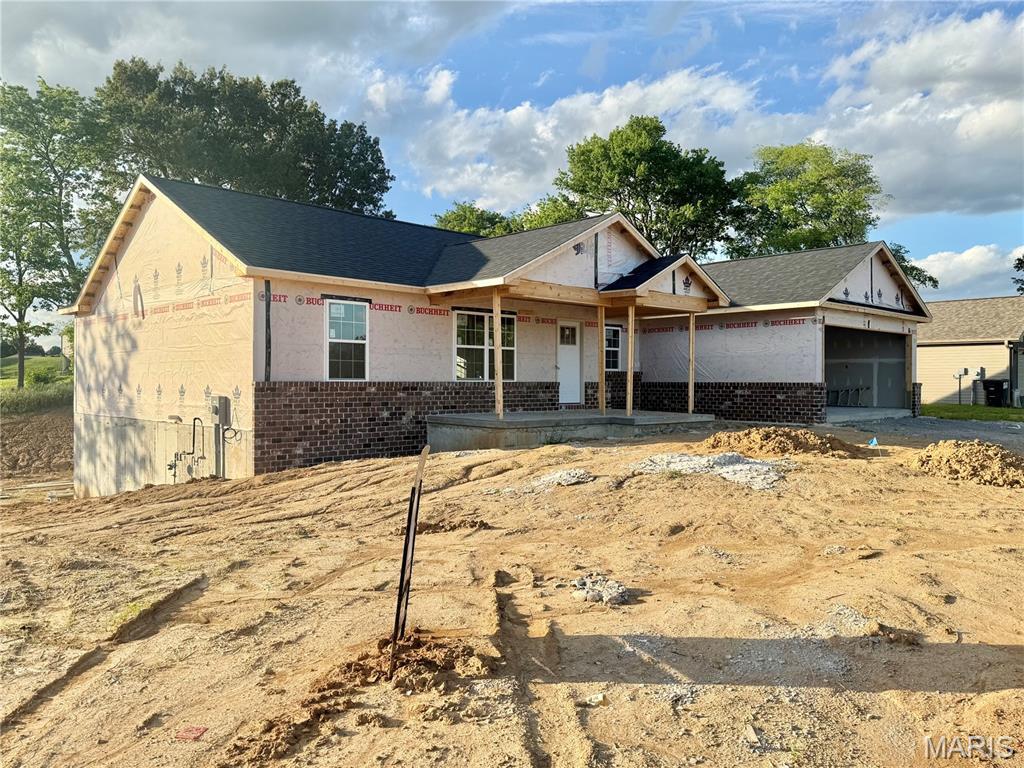 11 Bluebell Way, Jackson, MO 63755 - property in mid-construction featuring brick siding, an attached garage, and a porch