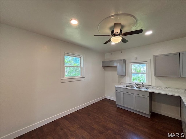 1014 E Broadway, Centralia, IL 62801 - kitchen with gray cabinetry, a sink, baseboards, plenty of natural light, and recessed lighting