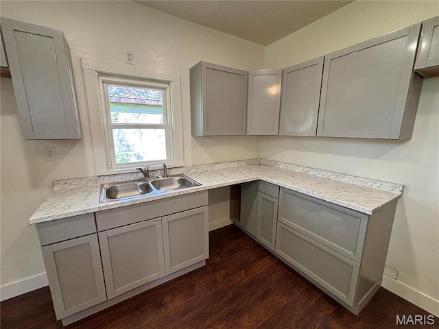 1014 E Broadway, Centralia, IL 62801 - kitchen featuring gray cabinetry, a sink, dark wood finished floors, baseboards, and light countertops