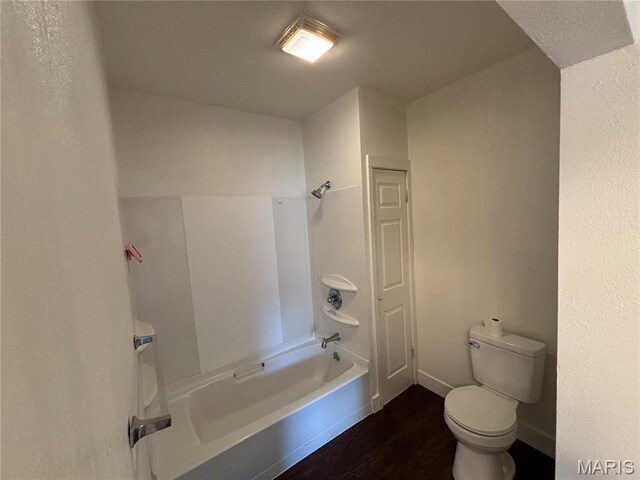 1014 E Broadway, Centralia, IL 62801 - bathroom featuring wood finished floors, toilet,  shower combination, and baseboards