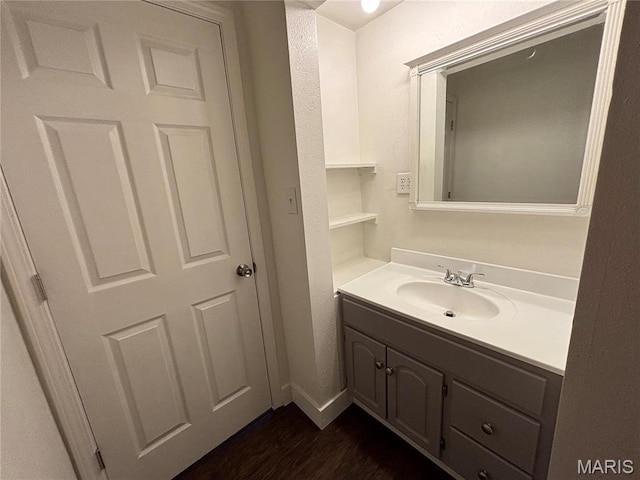 1014 E Broadway, Centralia, IL 62801 - bathroom with vanity, wood finished floors, and baseboards